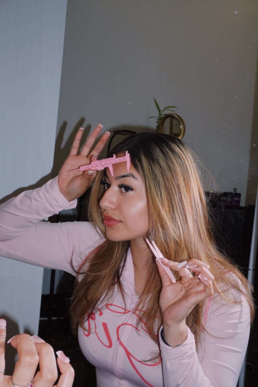 Jaz shaping brows in the studio